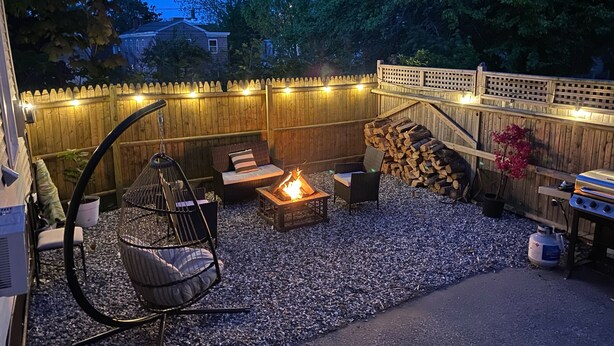 A backyard with a fire pit, seating area, and a grill. - Fabulous studio apartment with roof deck (Portland)