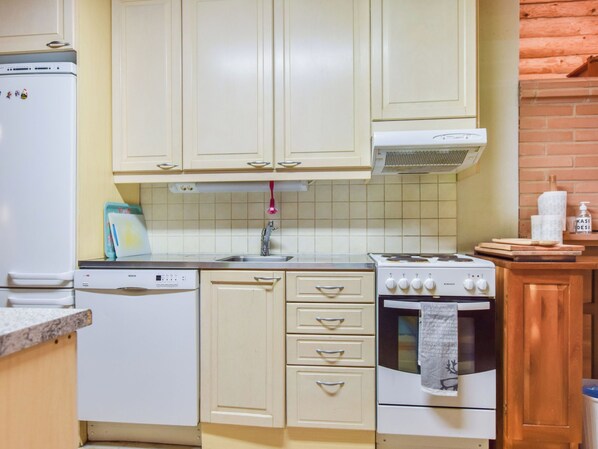 A kitchen with white cabinets, a Bosch dishwasher, a Beko oven, and a Beko stove.