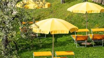 Outdoor seating with yellow umbrellas and wooden benches.