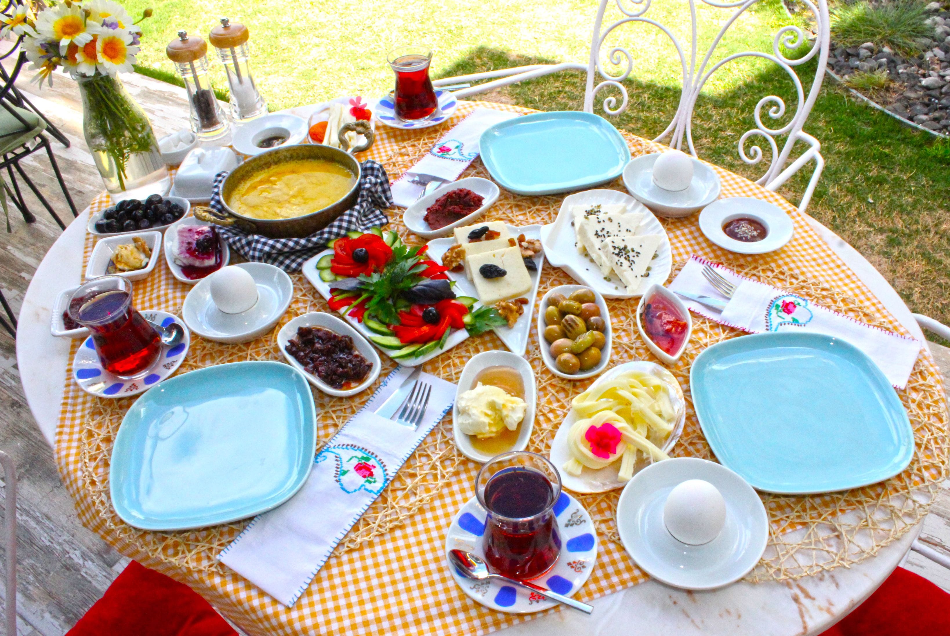 A table set with various dishes and drinks, likely for a meal.