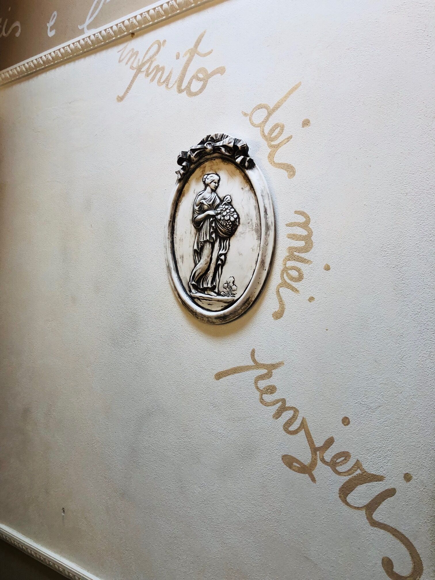 A decorative emblem with a figure holding a basket, surrounded by ornate text.