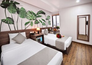 A hotel room with two beds, a wooden headboard, a nightstand with a lamp, a mirror, and a window with a city view. - Mega Light Hotel (Bac Nha Trang)