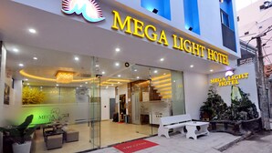The exterior of the Mega Light Hotel with a modern design, glass entrance, and a welcoming reception area. - Mega Light Hotel (Bac Nha Trang)