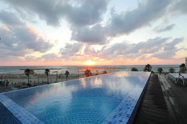 Seasonal outdoor pool, open 9:00 AM to 6:00 PM, pool umbrellas