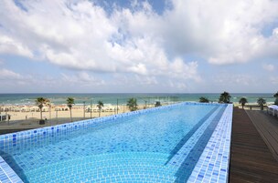 Una piscina con vista sulla spiaggia e sull'oceano.