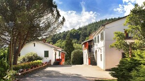 A two-story building with a central staircase and a small porch area. - 4 bed apartment with pool (Pontremoli)