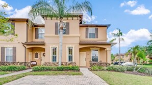 A two-story residential building with a brick pathway leading to the entrance. - Sept. Special 6th Night Free in Waterpark Resort & Spa, Golf, minutes to Disney (Davenport)