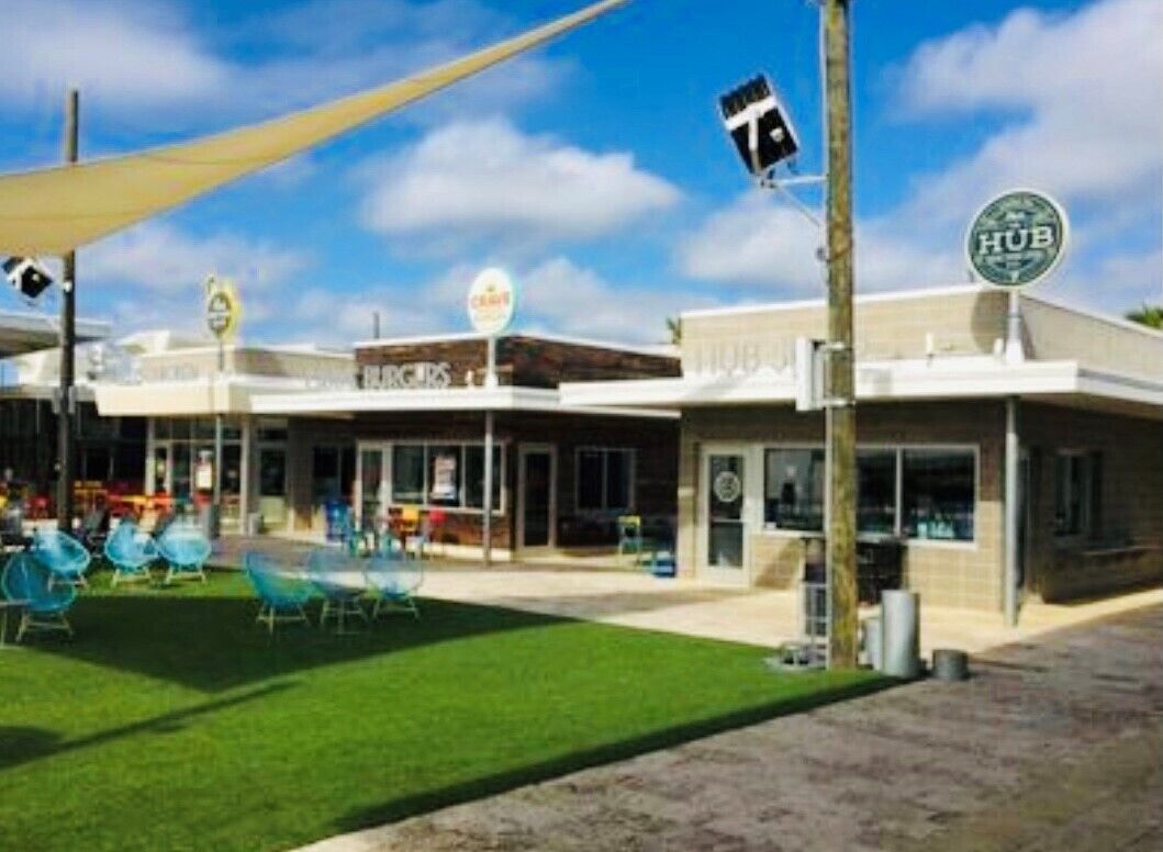 A building with a sign reading "HUB" and a sign for "Café".