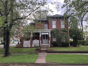 A two-story brick house with a front porch and a sign reading "The Kydde House." - Romantic Dogwood Room, Clawfoot Bathtub in Historic Hyde House, Hocking Hills (Nelsonville)