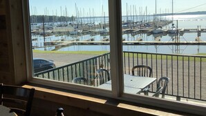 A view from a window of a restaurant with a table and chairs, overlooking a marina with boats. - Lake Texoma! Beautiful Cabin with Relaxing atmosphere!sleeps 5 (Gordonville)