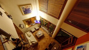 A cozy living room with a TV, sofa, and a fireplace. - Avista Villa (Sithonia)