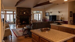 A spacious living area with a fireplace, a large TV, and a comfortable seating arrangement. - Nancy’s Touch, A Waterfront Paradise! (North East)