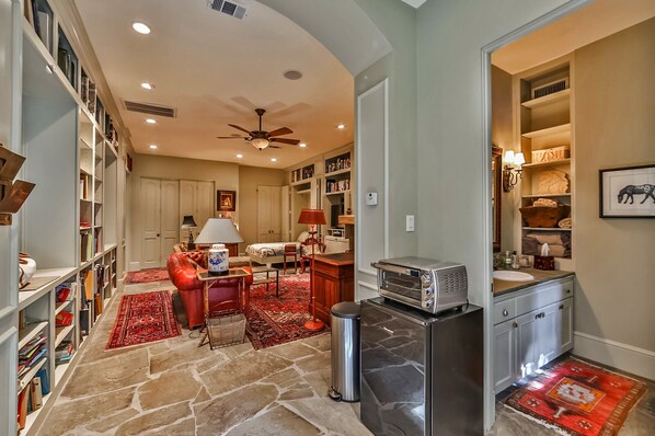 A spacious living room with a fireplace, a dining area, and a kitchen with a built-in toaster.