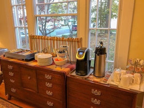A breakfast bar with a coffee maker, a thermos, and a mug holder. - Historic Primrose Bed & Breakfast Nelsonville! (Nelsonville)