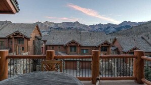 A wooden cabin with a balcony overlooking a mountainous landscape. - Villas at Tristant 205 (Mountain Village)