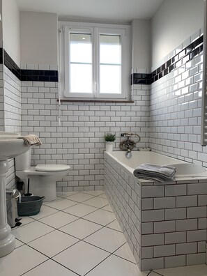 Bathtub, hair dryer, towels, soap