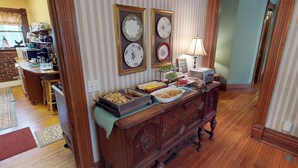 A kitchen with a wooden buffet table, a toaster, and a wall-mounted light. - Primrose Path Bed and Breakfast Hocking Hills between Logan and Athens (Nelsonville)