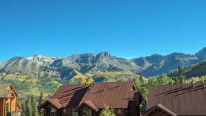 A mountain lodge with a wooden exterior and a view of the surrounding mountains. - Villas At Tristant 215 (Mountain Village)