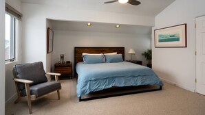 A bedroom with a bed, a chair, a nightstand, a lamp, a ceiling fan, and a window. - Spacious, private home .6 mi from downtown Ketchum (Ketchum)