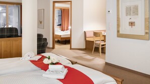 A hotel room with a bed, a desk, a chair, and a window. - Chalet Abendrot apARTments by Interhome (Grindelwald)