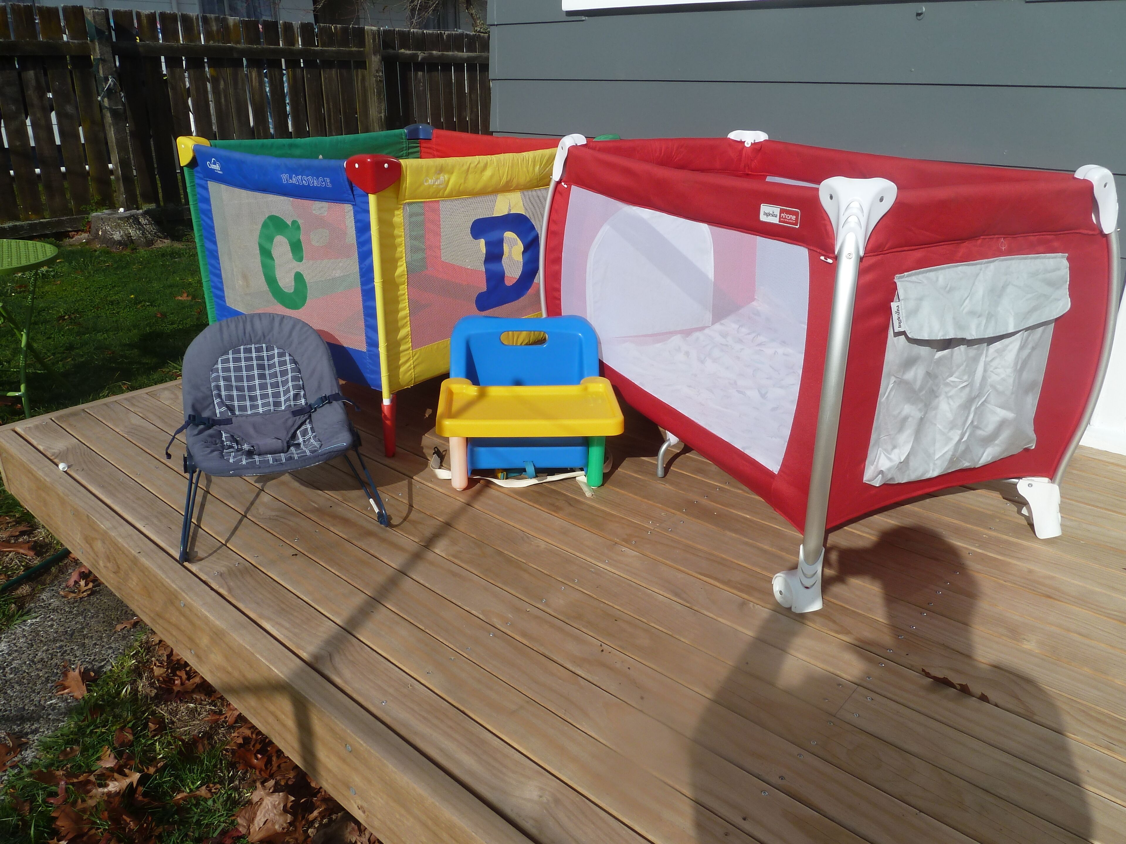 A play area with a playpen, a small table, and a chair.