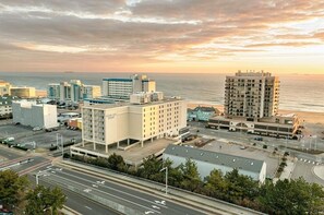 A coastal cityscape with a prominent hotel building, a marina, and a view of the ocean. - Ocean Key Resort - 1BR/1BA - Great Location across from Virginia Beach Boardwalk (Virginia Beach)