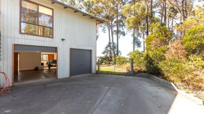 A two-story building with a garage and a covered outdoor area.