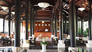 A spacious lobby with high ceilings, a central seating area, and a reception desk. - Chez Carole Center Resort & Spa (Phu Quoc)