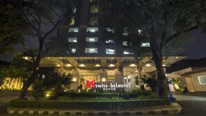 The Swiss-Belhotel Bogor exterior at night with illuminated windows and a well-maintained garden. - Swiss-Belhotel Bogor (Bogor)