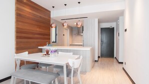 A modern kitchen with a central island, white cabinetry, and pendant lighting. - Boulevard Residence (Petaling Jaya)