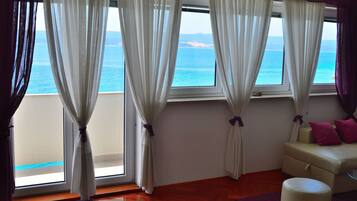 Apartment, 1 Bedroom, Balcony, Sea View | Living room | Flat-screen TV