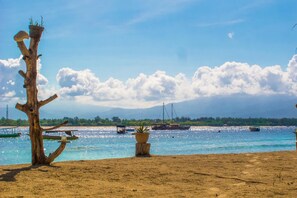 Ubicación cercana a la playa, arena blanca y toallas de playa