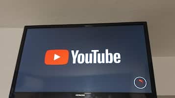 A flat-screen television displaying the YouTube logo.