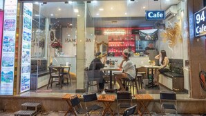A cafe with a glass front, seating area, and a sign indicating it is on the 94th floor. - Hanoi Asia Hotel (Hanoi)