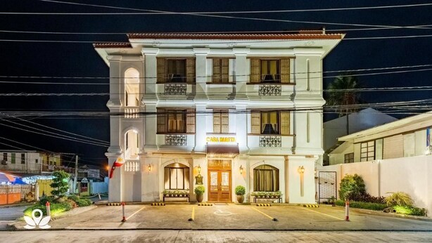 A two-story building with a central entrance, balconies, and a sign that reads "CASA MIBITA."