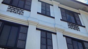 A building with the sign "CASA MARITA" and decorative ironwork on the windows.