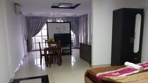 A hotel room with a bed, a desk, a chair, a television, and a wardrobe. - New Season Riverside Hotel (Phnom Penh)