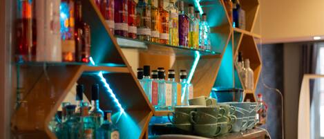 A bar area with shelves of liquor bottles and a coffee machine.