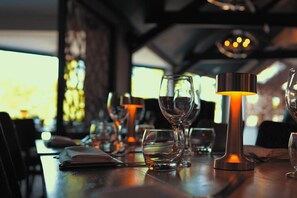 A dining table set with wine glasses and a candle. - The White Swan (Gainsborough)