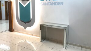 A hotel interior with a prominent 'LA MEXICANA SANTANDER' sign, a decorative wall feature, and a mirrored console table. - Hostal La Mexicana (Santander)