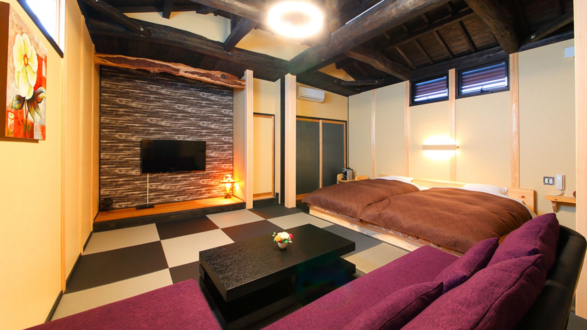A room with a checkered floor, a sofa, a flat-screen TV, and a wooden ceiling.