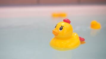 A yellow rubber duck floating in water.