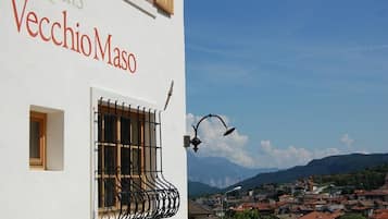 A building with a sign reading "Vecchio Moso" and a balcony with a wrought iron railing.