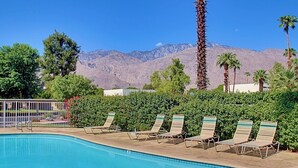 A pool area with lounge chairs and a mountain backdrop. - Villa Antonella (Palm Springs)
