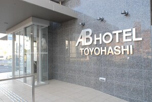 A hotel entrance with a glass door and a sign reading 'ABHOTEL TOYOHASHI'. - Ab Hotel Toyohashi (Toyohashi)