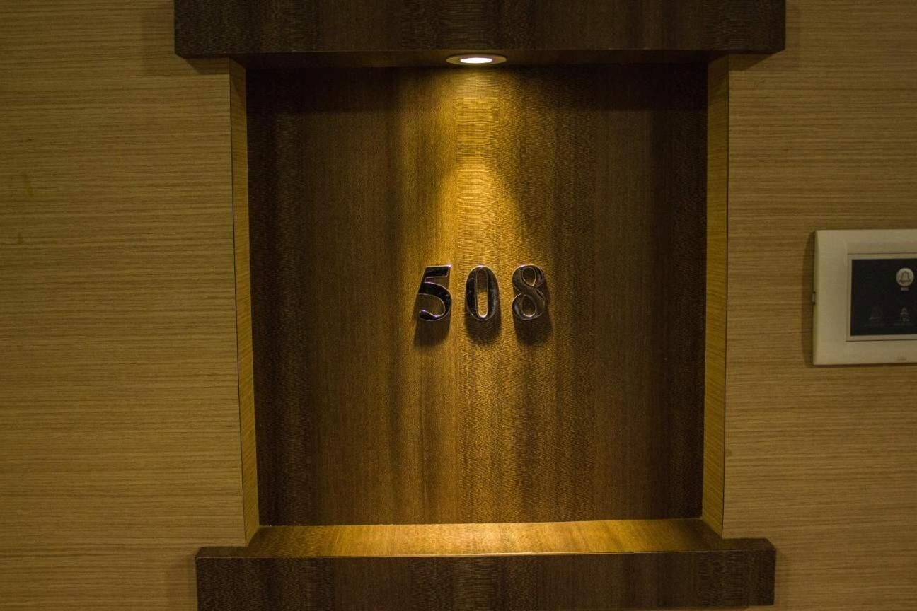 A wooden wall with the number 508 illuminated.