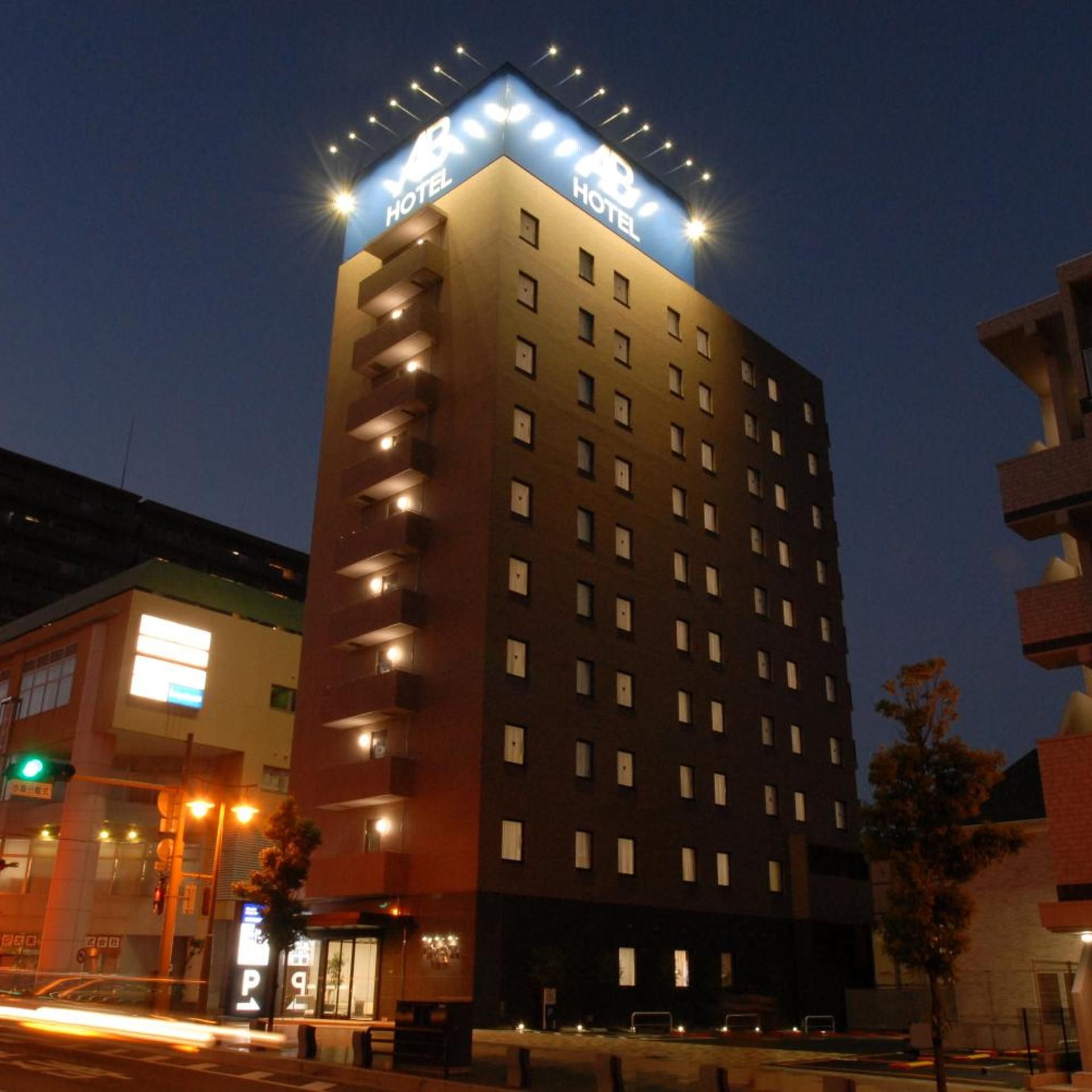 A multi-story hotel building with a prominent sign at the top.