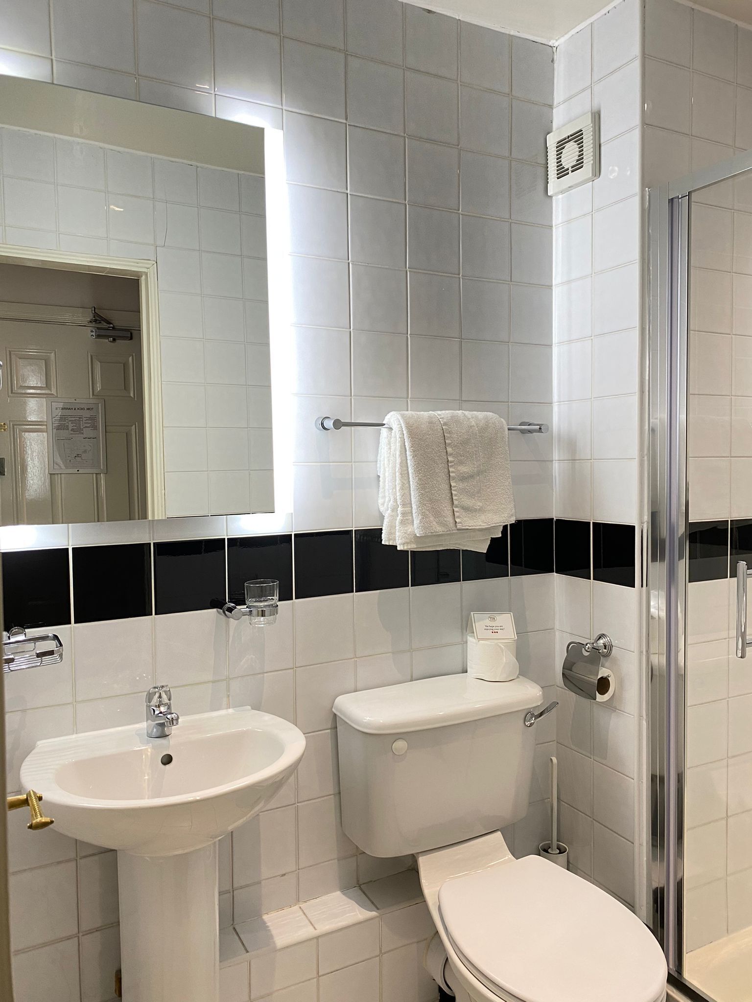 A bathroom with a sink, toilet, and shower.