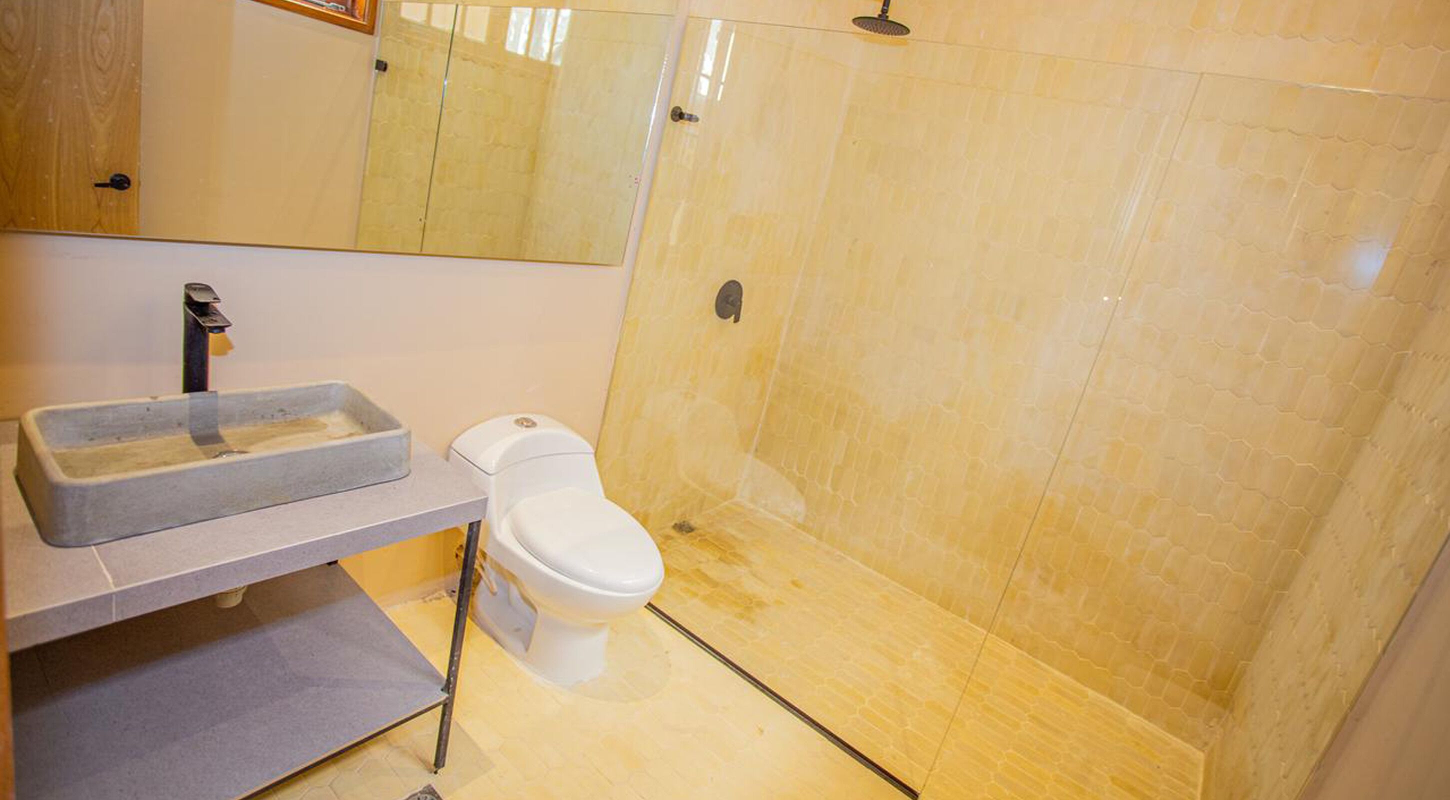 A bathroom with a sink, toilet, and shower.