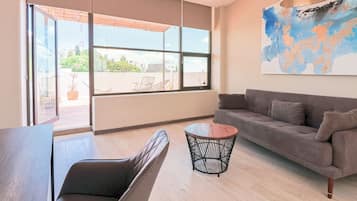 Deluxe Suite | Living area | 43-inch Smart TV with digital channels, streaming services